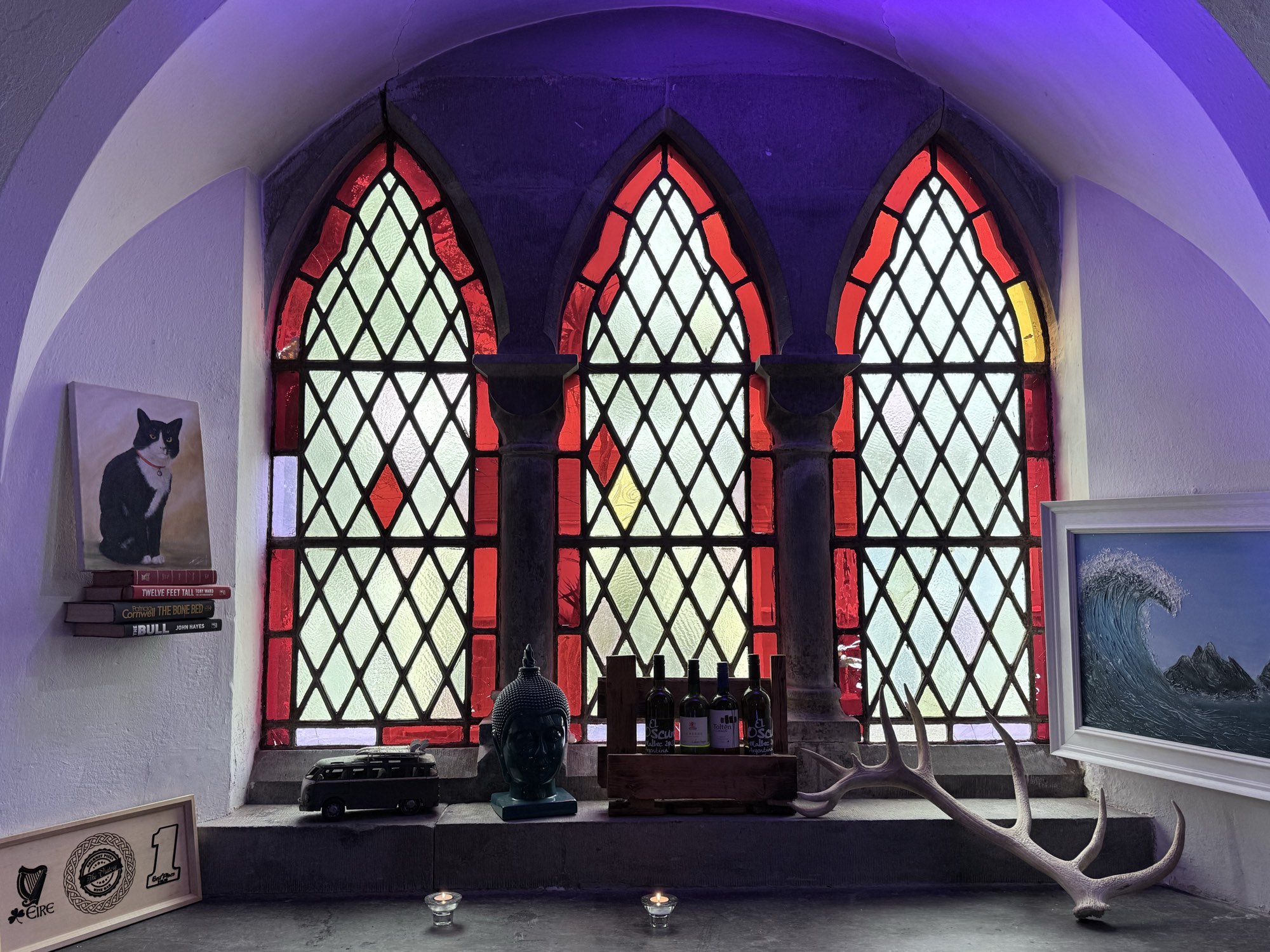 Candlelight and wine beneath the stained-glass window inside The Oratory, a converted Gothic church in Cahersiveen